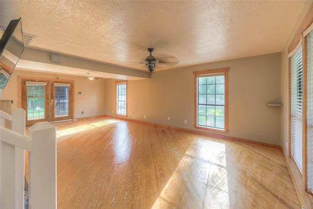 25 S Magnolia Ln, Shepherd, TX 77371 - unfurnished living room with light wood-type flooring, a ceiling fan, and a textured ceiling