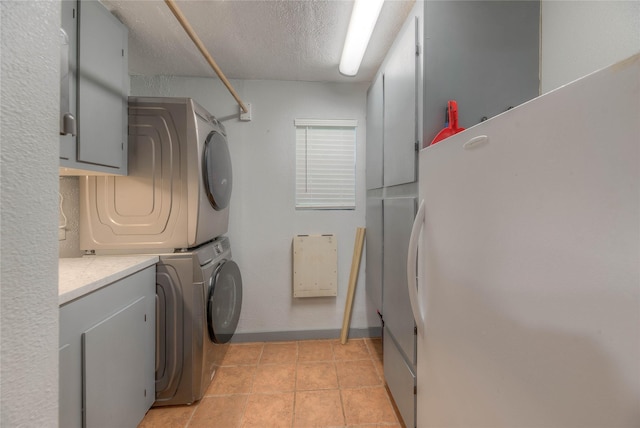 25 S Magnolia Ln, Shepherd, TX 77371 - laundry room with cabinet space, a textured ceiling, stacked washer and dryer, and baseboards