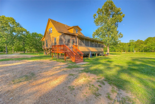 25 S Magnolia Ln, Shepherd, TX 77371 - back of property with a lawn, a sunroom, and stairway