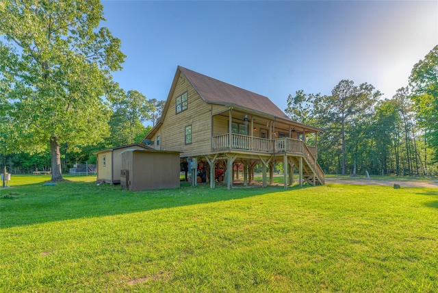 25 S Magnolia Ln, Shepherd, TX 77371 - back of house with an outdoor structure, stairs, a storage shed, ceiling fan, and a yard