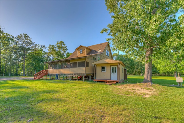 25 S Magnolia Ln, Shepherd, TX 77371 - back of property with stairway, a lawn, and a sunroom
