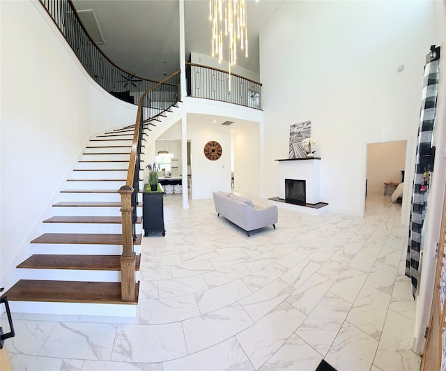 8006 Longridge Dr, Houston, TX 77055 - interior space featuring an inviting chandelier, marble finish floor, a towering ceiling, and a fireplace with raised hearth