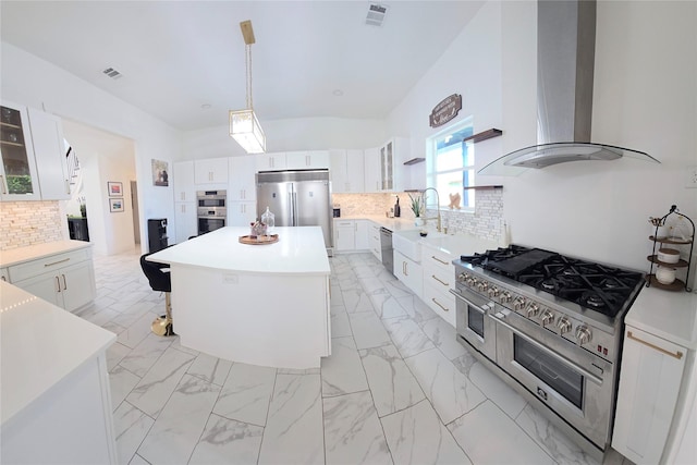 8006 Longridge Dr, Houston, TX 77055 - kitchen featuring wall chimney range hood, visible vents, a kitchen island, premium appliances, and backsplash