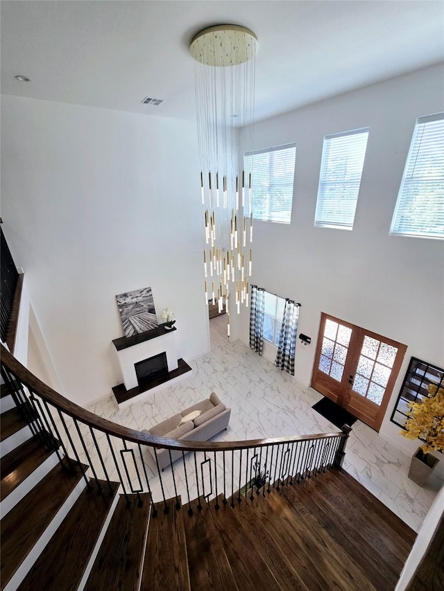 8006 Longridge Dr, Houston, TX 77055 - stairs featuring a towering ceiling, french doors, and visible vents