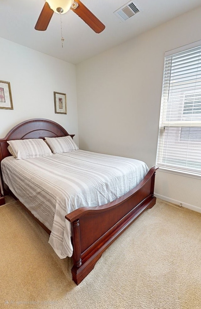 bedroom with carpet floors, ceiling fan, baseboards, and visible vents