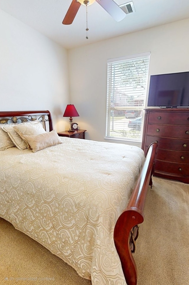bedroom with a ceiling fan, visible vents, and light carpet