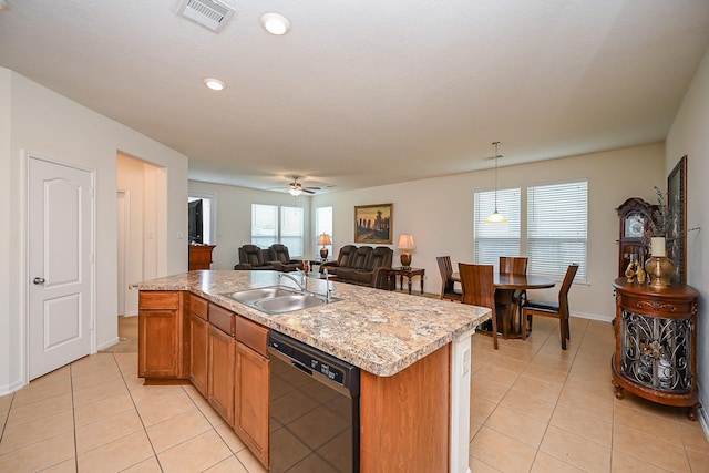 kitchen with a sink, light tile patterned floors, open floor plan, and dishwasher
