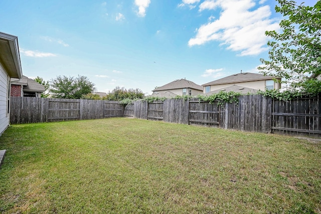view of yard with a fenced backyard