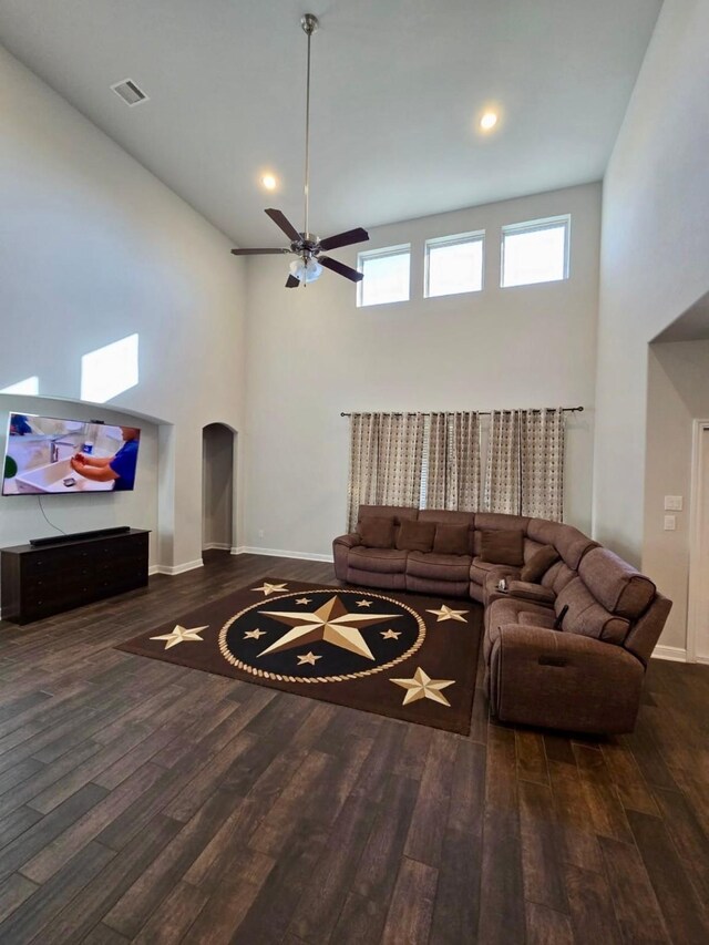 19003 Bene Vista Dr, Houston, TX 77084 - living area with wood finished floors, arched walkways, baseboards, ceiling fan, and a towering ceiling