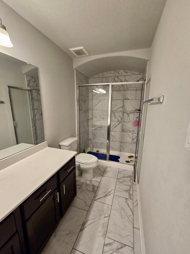 19003 Bene Vista Dr, Houston, TX 77084 - full bath featuring marble look tile flooring, vanity, a marble finish shower, and toilet