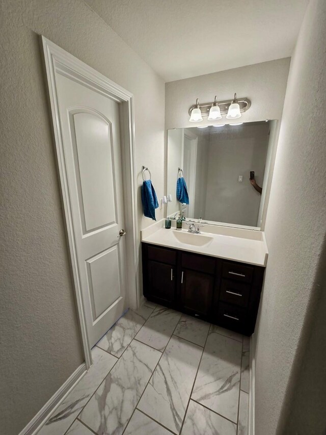 19003 Bene Vista Dr, Houston, TX 77084 - bathroom with marble finish flooring, vanity, and a textured wall