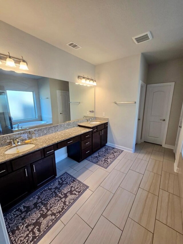 19003 Bene Vista Dr, Houston, TX 77084 - full bathroom featuring double vanity, baseboards, wood finish floors, and a tub