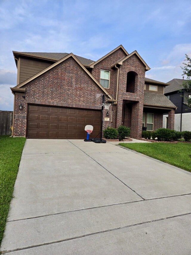 19003 Bene Vista Dr, Houston, TX 77084 - view of front of house featuring brick siding, concrete driveway, an attached garage, and a front yard