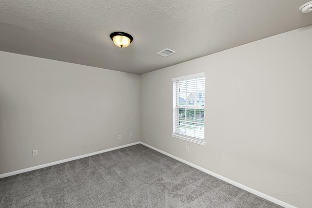 26818 Lindenwood Creek Ln, Katy, TX 77494 - empty room with dark colored carpet and a textured ceiling