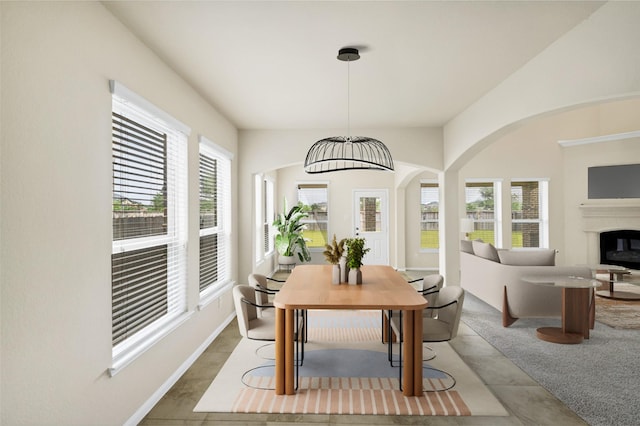 26818 Lindenwood Creek Ln, Katy, TX 77494 - dining space with arched walkways and a glass covered fireplace