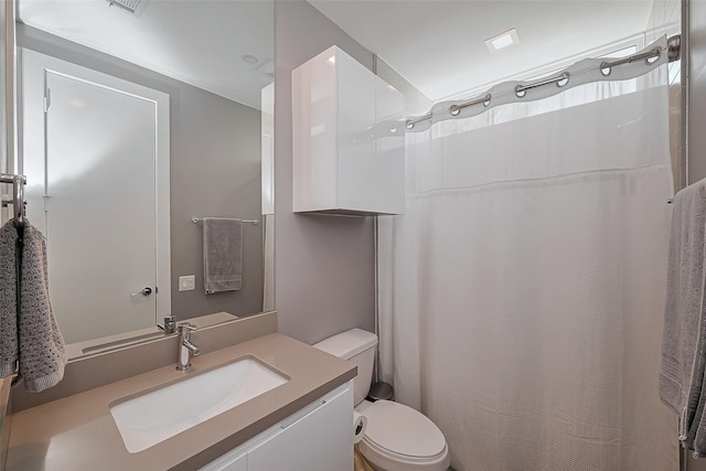 bathroom with vanity, toilet, and curtained shower