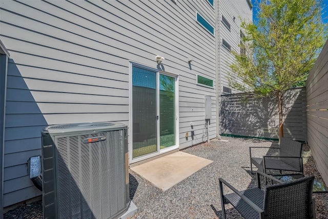 view of patio / terrace with central AC and fence