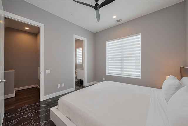 bedroom featuring visible vents, ensuite bathroom, baseboards, a ceiling fan, and marble finish floor