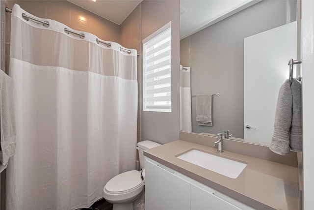 full bathroom featuring toilet, vanity, and a shower with shower curtain