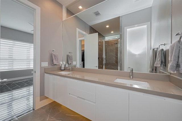 full bath featuring a sink, a shower stall, marble finish floor, double vanity, and visible vents