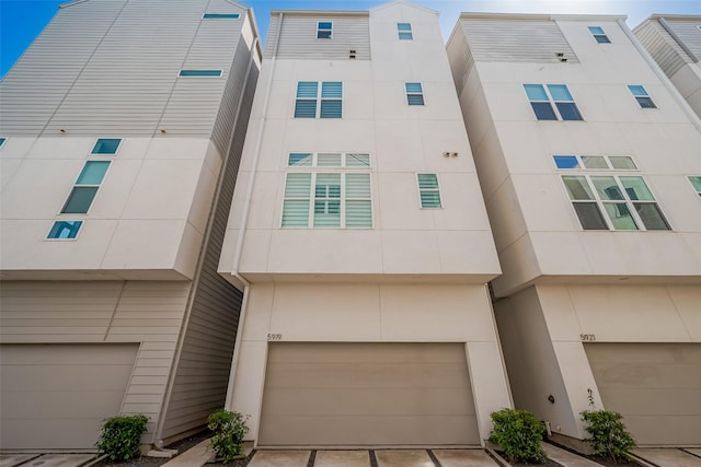 multi unit property with driveway and an attached garage