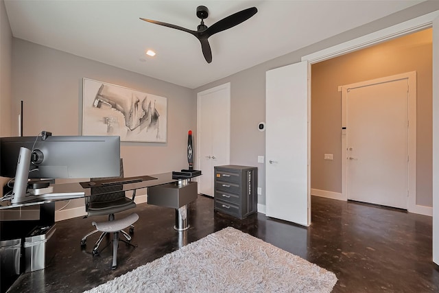 office area with baseboards, ceiling fan, and finished concrete floors