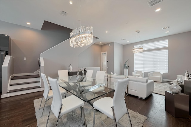 dining space featuring stairway, a chandelier, and visible vents