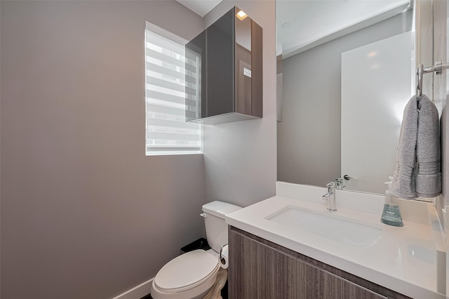 bathroom with toilet and vanity