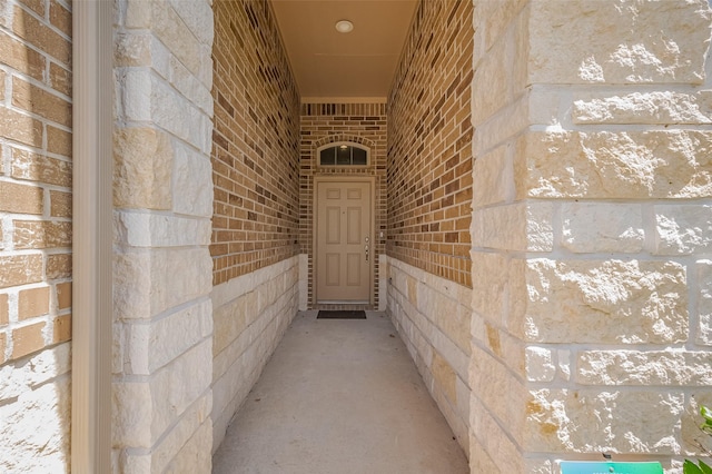 property entrance with brick siding