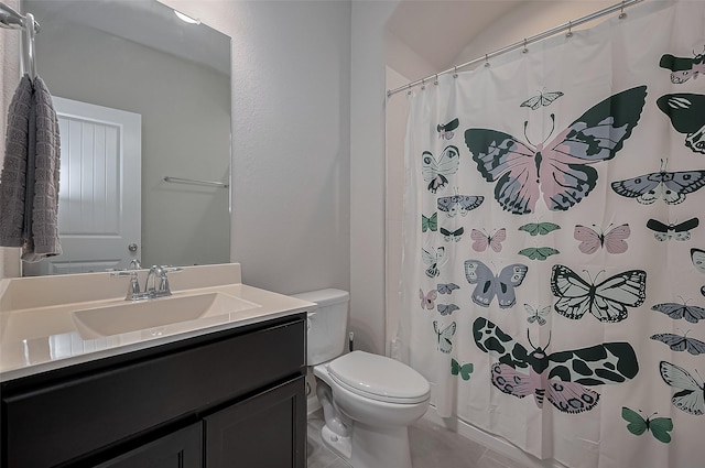 bathroom featuring vanity, curtained shower, and toilet