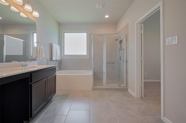 full bath featuring a garden tub, vanity, tile patterned flooring, and a stall shower