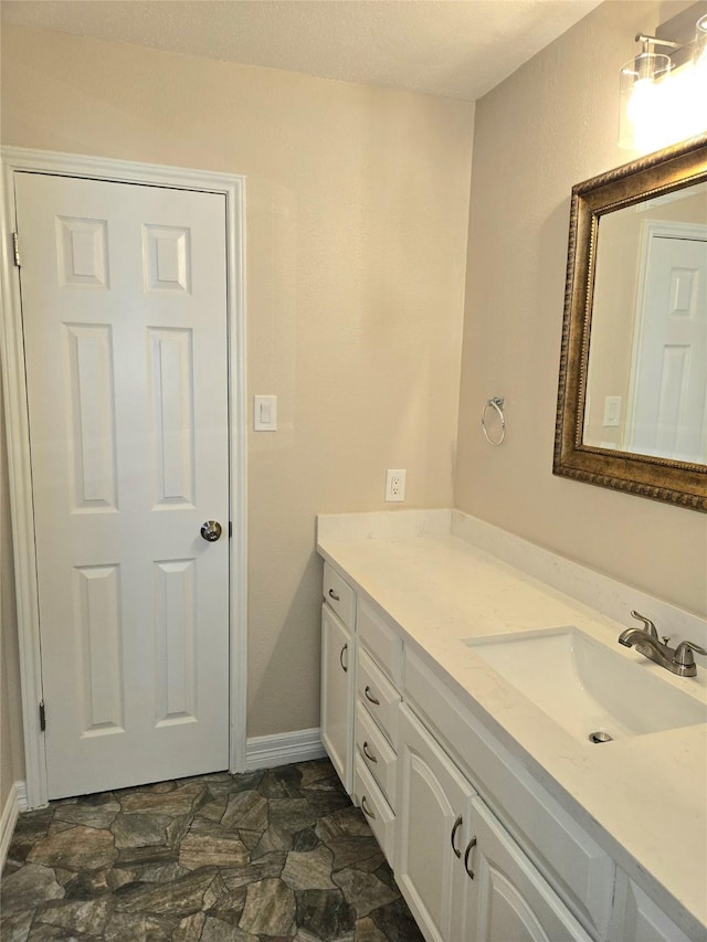12325 Ridgeside Dr, Houston, TX 77072 - bathroom with vanity, stone finish floors, and baseboards