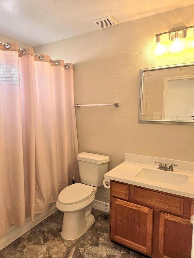 12325 Ridgeside Dr, Houston, TX 77072 - full bathroom with vanity, toilet, and a textured ceiling