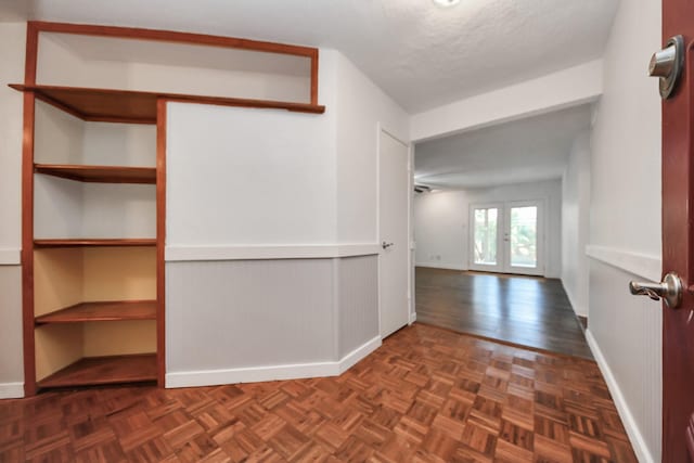 1409 N Park Ridge Dr, Deer Park, TX 77536 - hall featuring baseboards, a textured ceiling, and parquet floors