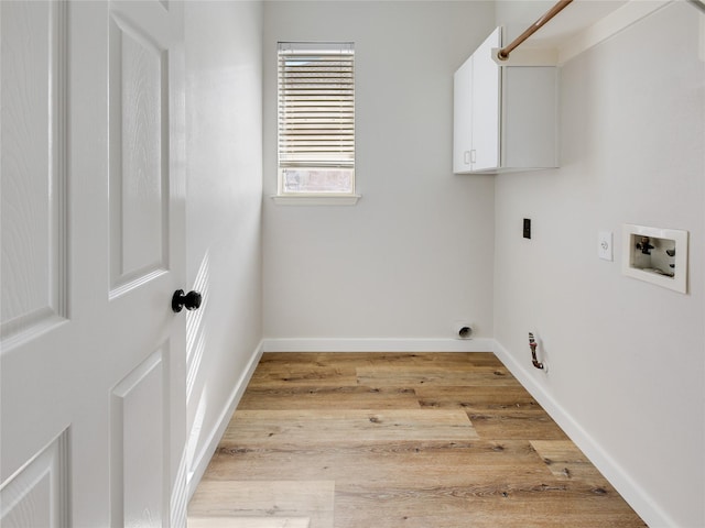 laundry area with hookup for an electric dryer, baseboards, light wood-style flooring, hookup for a washing machine, and cabinet space