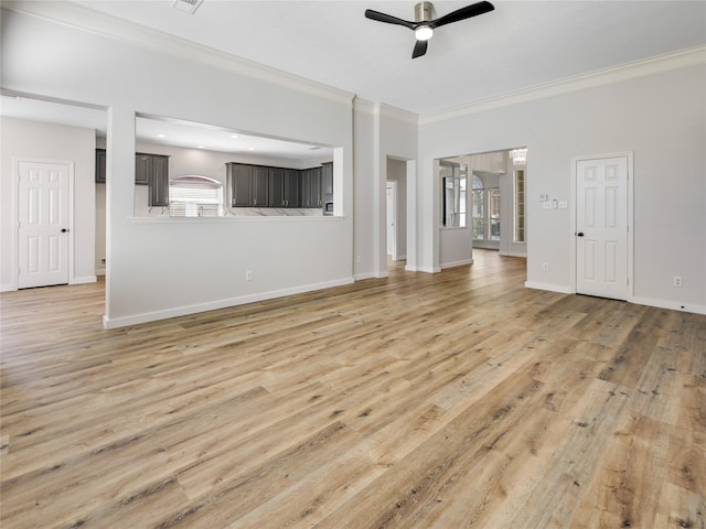 unfurnished living room with plenty of natural light, light wood finished floors, crown molding, and a ceiling fan