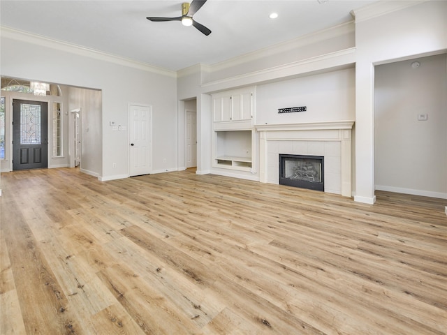 unfurnished living room with light wood-style flooring, crown molding, ceiling fan, and baseboards
