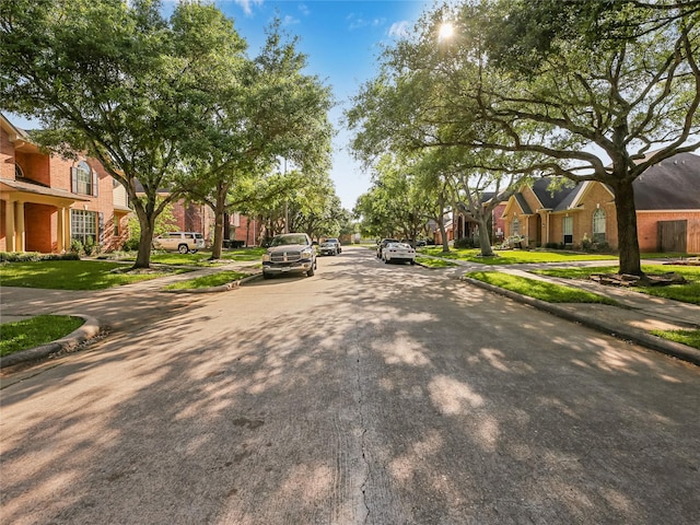 view of road featuring curbs, a residential view, and sidewalks