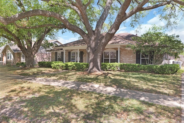 ranch-style house featuring brick siding and a front lawn