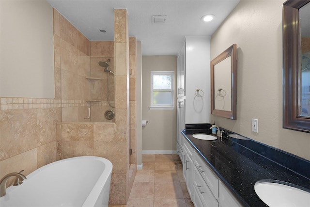 full bath with a sink, a tile shower, double vanity, and a freestanding tub