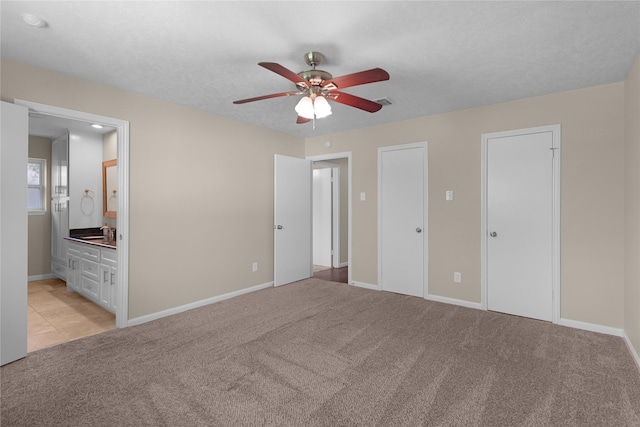 unfurnished bedroom featuring light colored carpet and baseboards