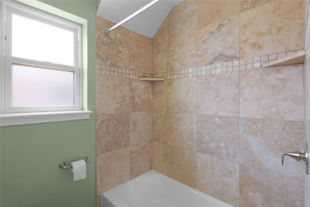 bathroom featuring shower / bathing tub combination and lofted ceiling