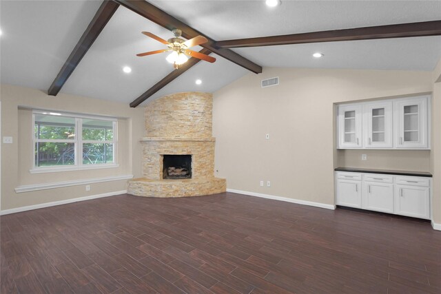 unfurnished living room featuring vaulted ceiling with beams, visible vents, baseboards, and a ceiling fan
