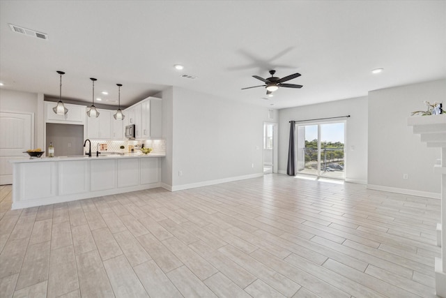 6804 Westview Dr Unit 1407, Houston, TX 77055 - unfurnished living room with visible vents, a sink, ceiling fan, and recessed lighting