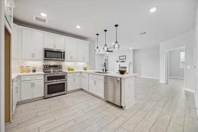 6804 Westview Dr Unit 1407, Houston, TX 77055 - kitchen featuring stainless steel appliances, a peninsula, visible vents, and a sink