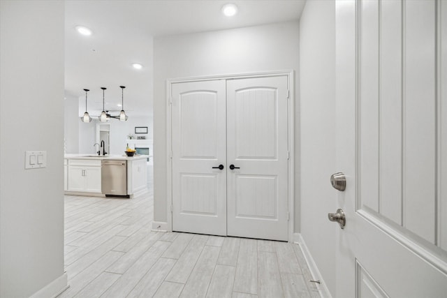 6804 Westview Dr Unit 1407, Houston, TX 77055 - hallway with a sink, baseboards, light wood-type flooring, and recessed lighting
