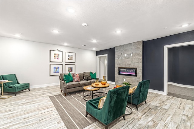 6804 Westview Dr Unit 1407, Houston, TX 77055 - living room featuring light wood-style floors, a tiled fireplace, baseboards, and recessed lighting