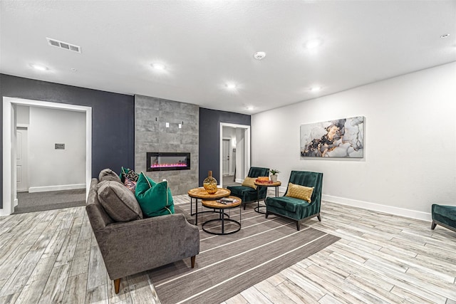 6804 Westview Dr Unit 1407, Houston, TX 77055 - interior space featuring a tile fireplace, visible vents, wood finished floors, and baseboards