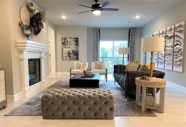 living area with visible vents, ceiling fan, recessed lighting, wood finished floors, and a glass covered fireplace