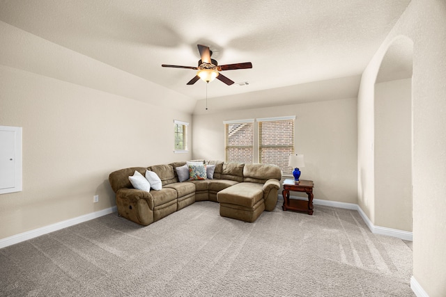 living room featuring carpet floors, a ceiling fan, baseboards, and visible vents